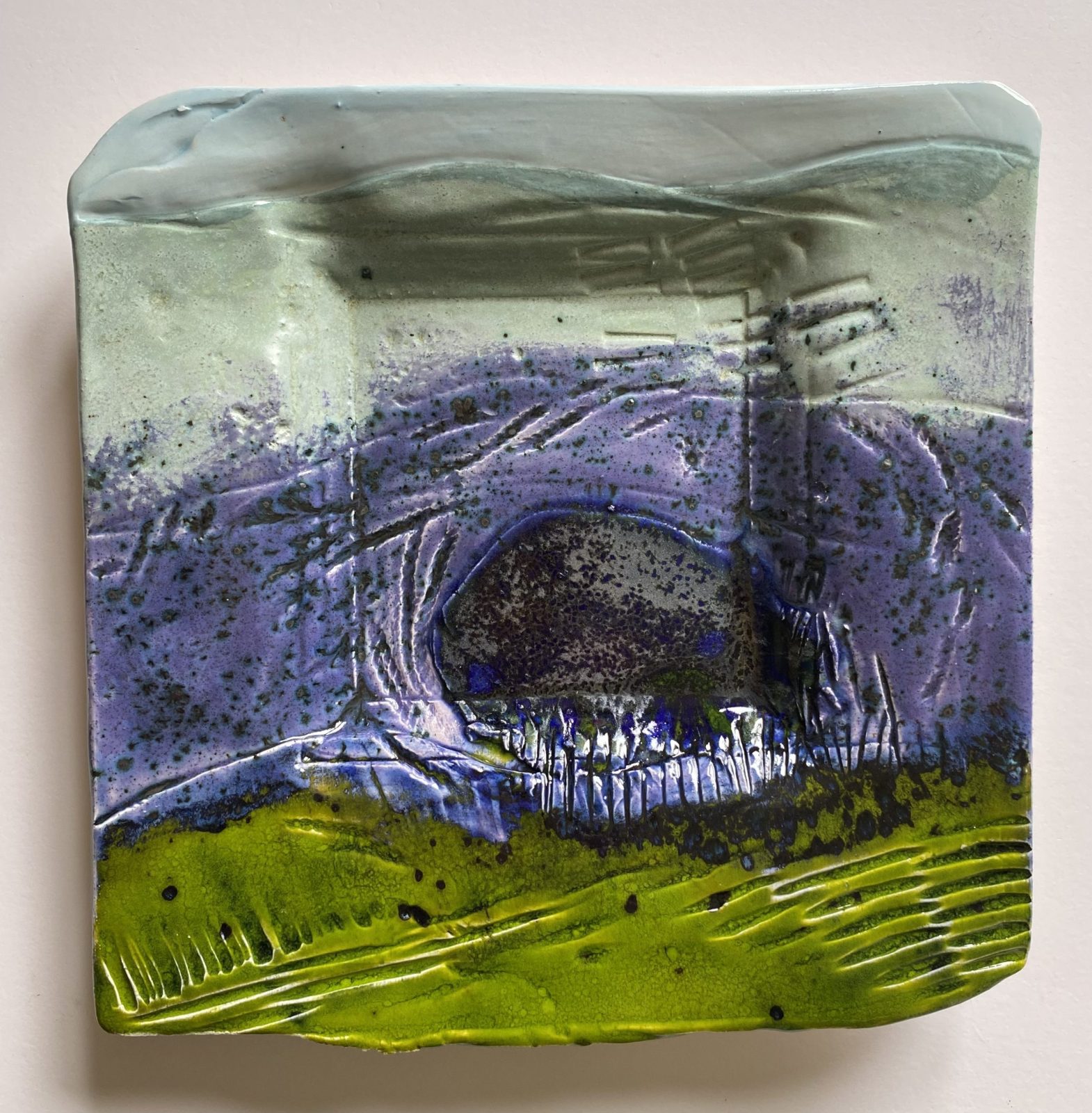 Ceramic landscape with purple and green stripe and metallic blue lake